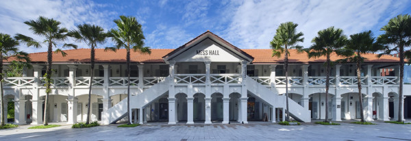 "Mess Hall" building, two-story white facade with red tile roof and palm trees against a blue sky.